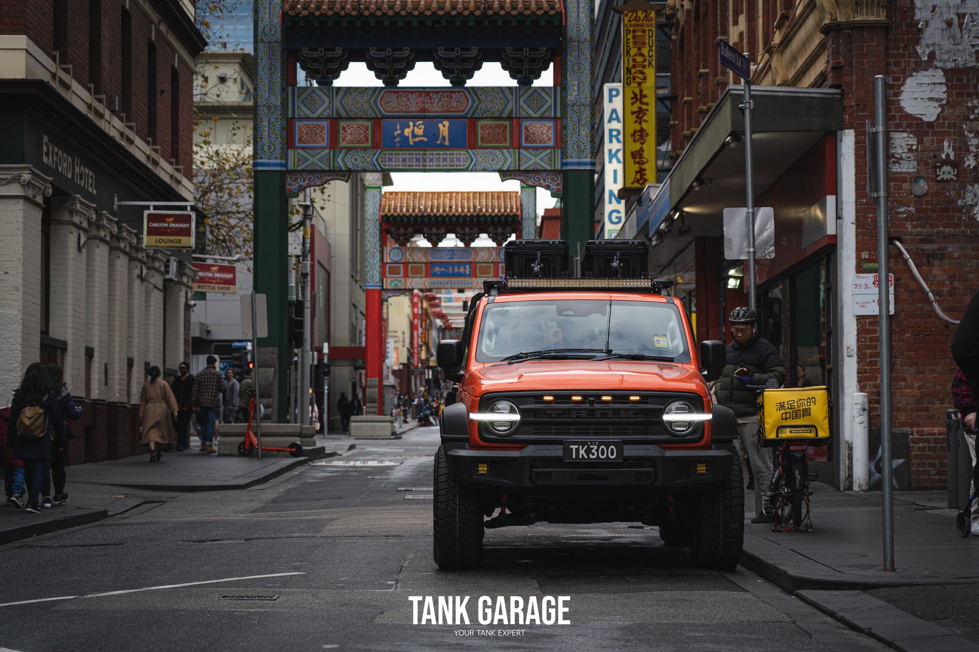 An orange Tank 300 with the War God front grille and TANK 300 Front Bumper "Gulfstream," parked in Melbourne's Chinatown.