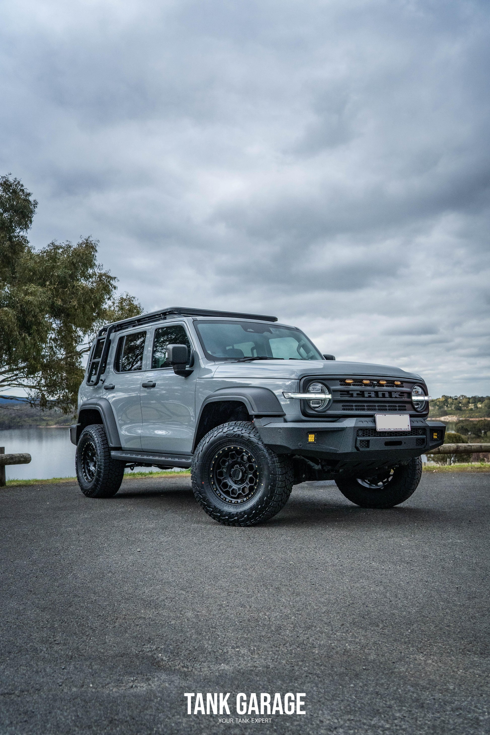 A grey Tank 300 featuring a TKG roof rack, the War God front grille, and the TANK 300 Front Bumper "Gulfstream."