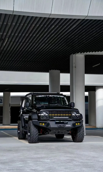 A black Tank 300 with a top fire front grille "Darkness" and yellow daytime running lights illuminated.